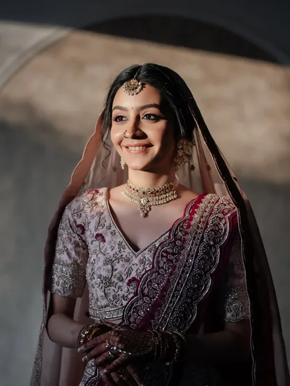 Bathed in sunlight, her makeup looks ethereal and her smile is infectious. This is the essence of a happy, glowing bride.