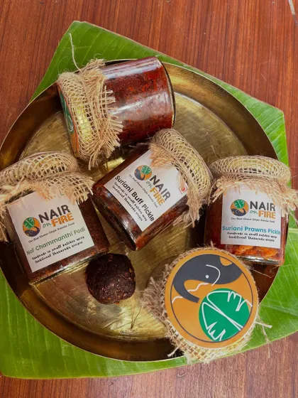 This is the heart of my kitchen, bottled for yours. My signature Suriani Buff and Prawn Pickles, alongside the essential Chammanthi Podi, are all handmade in small batches. Presented on a traditional brass thali, this is a glimpse into the authentic, unapologetic flavours of my family's Tharavadu recipes.