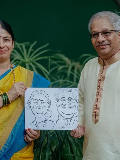 A family member holds up a caricature drawing of the couple, one of the many fun and personalized activities I can arrange for your guests.