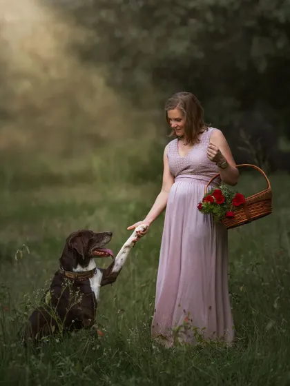 A maternity portrait with a furry friend giving a "handshake" to his expecting mom. It’s a sweet, funny, and heartwarming way to include the whole family in this special milestone.
