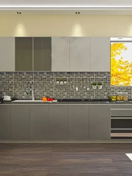 An L-shaped kitchen with grey modular cabinets and a dark mosaic tile backsplash. The layout is designed for a practical workflow, with the fridge, sink, and stove in close proximity.