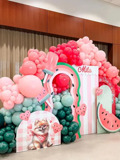 The complete "One in a Melon" setup, a perfect theme for a summer birthday. The design is full of fun shapes and bright colors, creating a cheerful and festive party atmosphere.