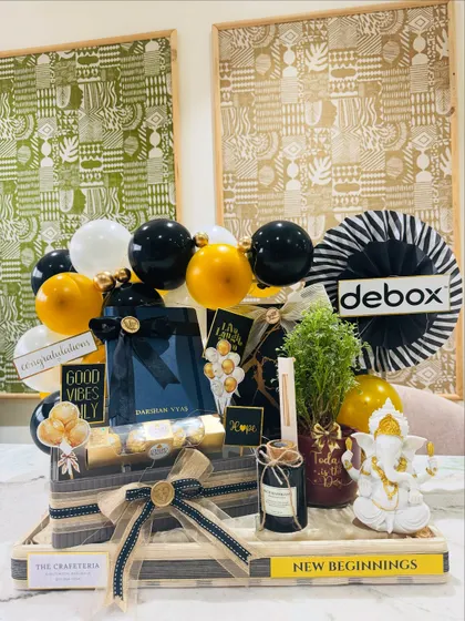 We curated this bold black and gold themed hamper for a new office inauguration. It sets a tone of confidence and prosperity with a Ganesha idol for blessings, a live plant for growth, a personalized diary for new ideas, and the company's logo for a bespoke corporate touch.