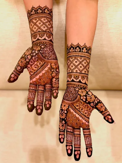 An alternate angle of Samiksha's engagement mehendi, showing the design's coverage on the back of the hands.
