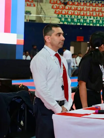 Focused while serving as a judge at a national-level competition. My role requires complete impartiality and a deep understanding of technique and spirit.