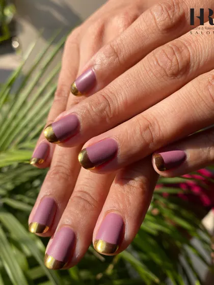 A modern and chic color combination. We used a beautiful matte mauve polish as the base and added a crisp, metallic gold French tip for a look that is both trendy and sophisticated.