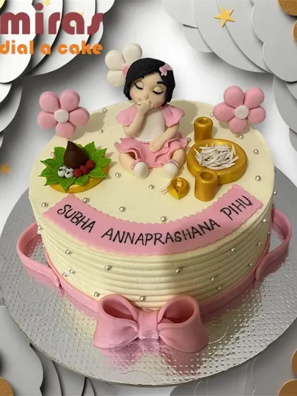 A beautiful cake for an Annaprashana, or first rice-eating ceremony. The design features a baby girl figurine and traditional elements, all crafted with care for this special rite of passage.