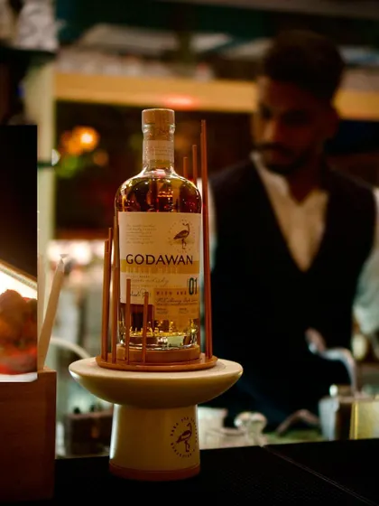 A bottle of Godawan 'Fruit & Spice' single malt, the star of our new menu preview. This image highlights our collaboration with premium Indian brands to create unique and localized fine dining experiences.
