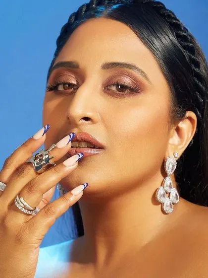 A French manicure fit for a queen. For The Kumari Queen, we did a sharp, deep blue V-shaped French tip that was both edgy and elegant.