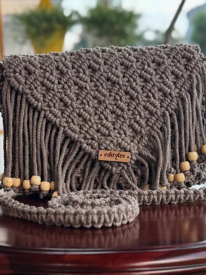 A close-up of the fringe and bead details on my brown boho sling bag. The wooden beads add a natural, earthy touch to the design.
