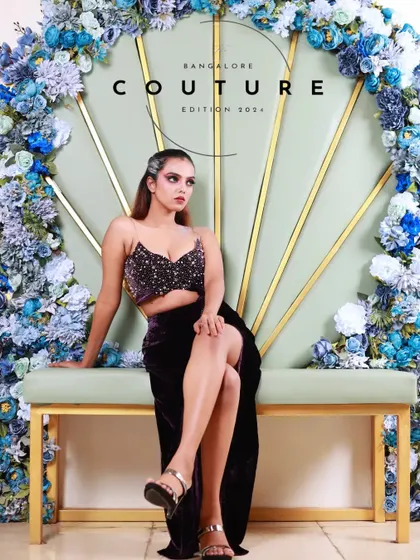 A full-length shot of a model seated against a beautiful floral backdrop. This image from the Bangalore Couture Edition promo shows my attention to set design and overall composition.