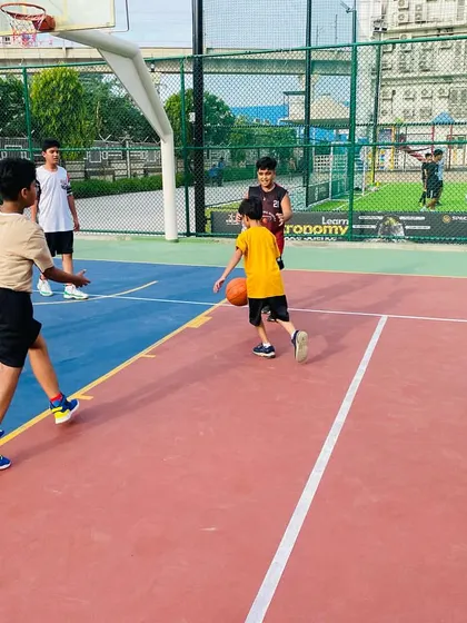 A young player practices dribbling while navigating through cones (not pictured).
