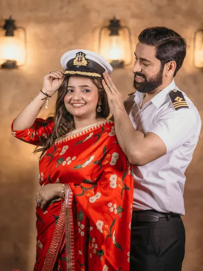 A cute, playful moment where she tries on his hat, capturing the fun dynamic of the couple.