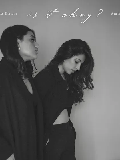 The album artwork for 'Is It Okay?'. This black and white portrait of Amira and Anahita captures the vulnerability and courage of their music.