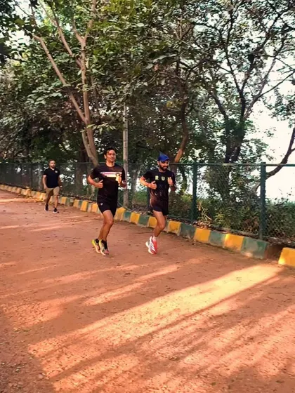 Two runners stride for stride during a Sunday long run. Pacing with a partner helps you stay consistent and push through tough miles.