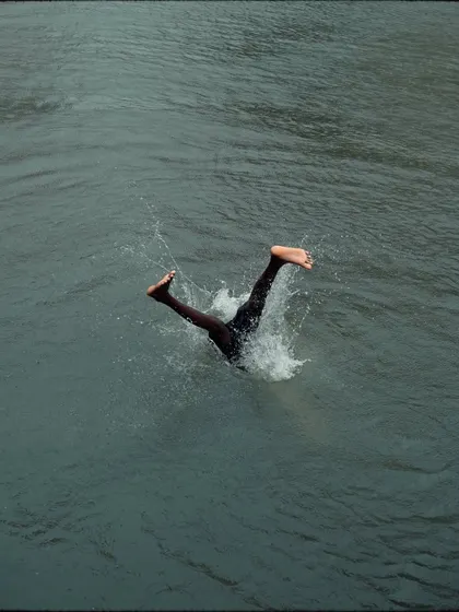 The splash after the dive. This action shot captures the impact and energy of a boy landing in the water at Banganga.