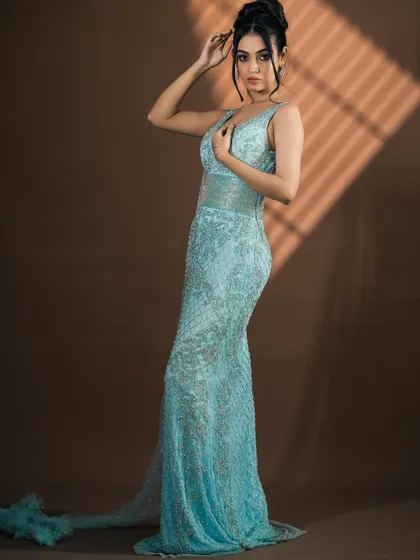 A full-length view of the light blue gown, emphasizing its elegant train and form-fitting design. A true red-carpet rental piece.