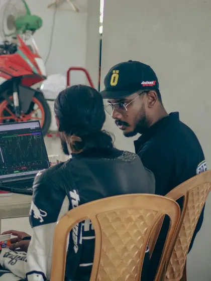 One of our instructors reviewing telemetry data with a rider. This one-on-one feedback is invaluable for understanding the physics of riding fast.