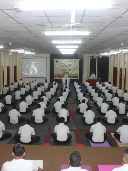 The stillness and unity in a large hall during an Army yoga session. Each participant is fully engaged, creating a powerful atmosphere for transformation.