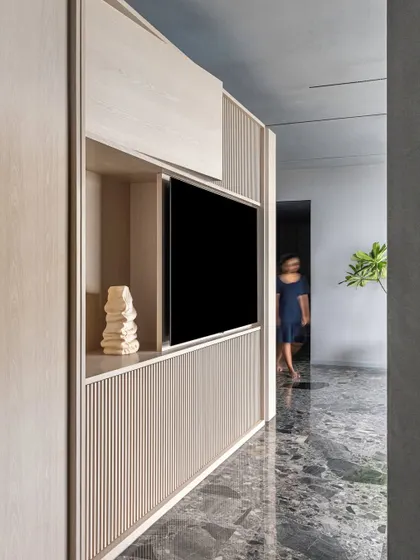 An angular view of the kitchen block, emphasizing how detaching it from the ceiling allows natural light to flow deeper into the space.