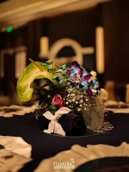 Even the smallest floral arrangements were designed with care. This petite centerpiece features an exotic anthurium and vibrant orchids, adding a touch of sophisticated color to the tablescape.