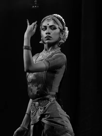 A powerful black and white still, where the hand mudra and intense gaze tell a story of their own. This captures the dramatic potential of Bharatanatyam.