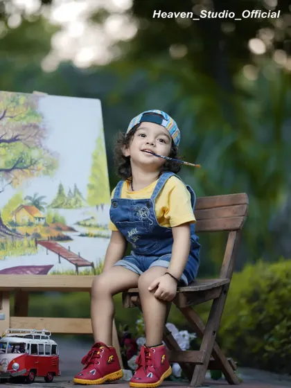 Little hands, big imagination. This charming photo from an 'Artist' themed shoot shows a young boy ready to create his next masterpiece.