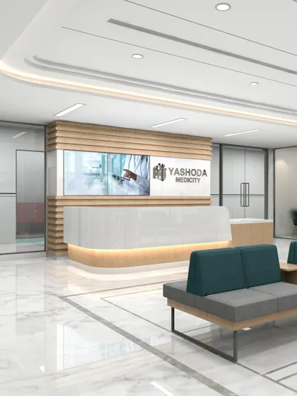 The reception desk at Yashoda Medicity, as shown in this render, is clean and modern, with integrated digital screens. The design prioritizes efficiency and clear communication in a high-traffic area.