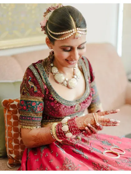 A close-up of the bride admiring her bangles. It's these small, personal moments that add so much character to a wedding story.