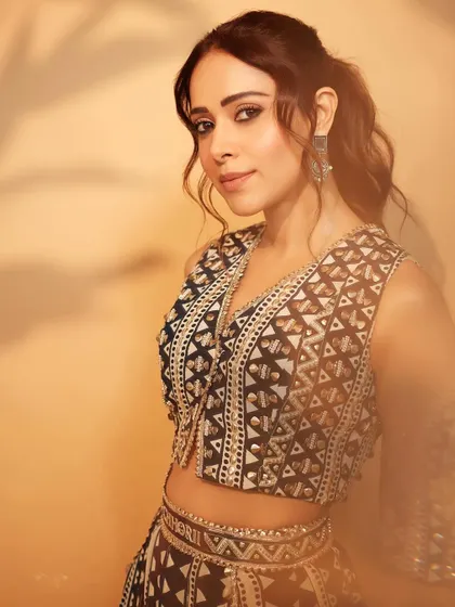 A close-up of Nushrratt's promotional look, showing off the intricate beadwork and her confident expression.