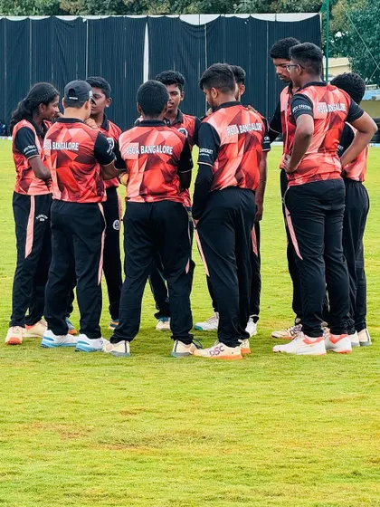 The team huddles up for a strategy discussion during a Dasara Cup match, a crucial part of on-field leadership.