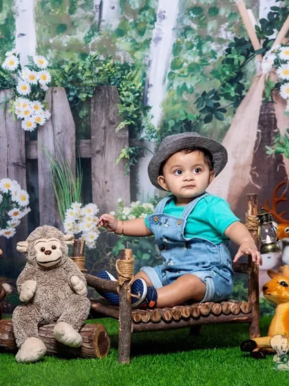 A calm and curious toddler in a woodland scene. The gentle lighting and his thoughtful expression give this photo a sweet, storybook feel.