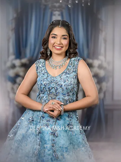 A full-length shot of the model in her stunning blue gown. This look is perfect for a reception or a formal event, combining elegance with a touch of sparkle.