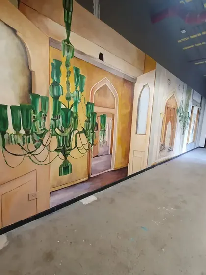 A full shot of the Microsoft corridor mural, showcasing the interplay of light and shadow in the painted architecture.
