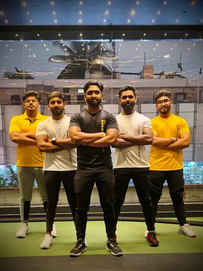 This is our team, the lions of Dhanu's Gold Fitness. We stand together with our arms crossed, ready and committed to helping you achieve your fitness ambitions.