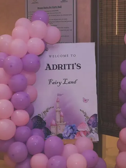 The full entrance setup for the 'Fairy Land' party, with a pink and purple balloon garland.