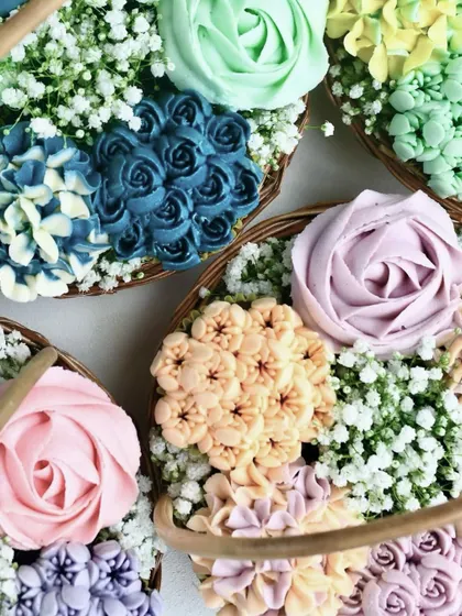 A top-down shot focusing on the variety of my buttercream floral designs. I create different shapes and colors, like roses and hydrangeas, to make each basket unique and visually striking.