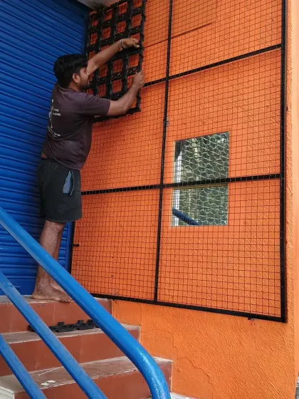 Here you can see the installation process in action. My team member is carefully fitting the first few modular panels of the living vertical garden onto the pre-installed grid.