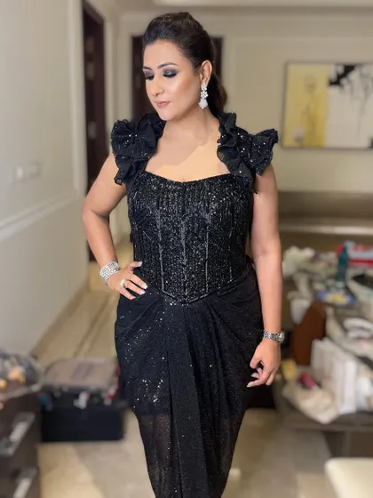 This full-length shot shows how a dramatic eye can balance a show-stopping black gown. It's a look that exudes confidence and style.