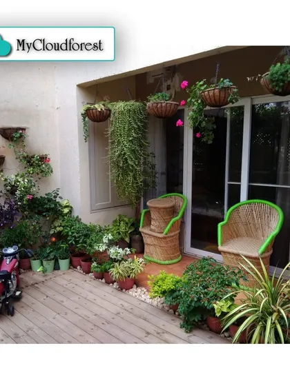 This cozy patio demonstrates how even a small space can be transformed into a plant lover's paradise. I used a mix of hanging baskets, wall-mounted planters, and floor pots to create a dense, multi-level urban jungle.