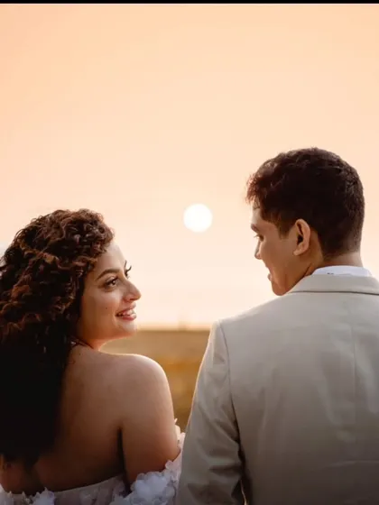 A beautiful sunset shot. The silhouette of the couple against the golden sky is the perfect romantic ending to their wedding day.