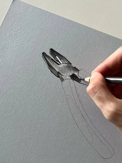 An early stage of the pliers drawing. The initial sketch is complete, and I am beginning to render the metallic head, establishing the light source and shadows.