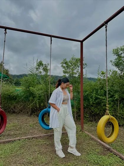 A relaxed, all-white look for a day in nature. A white shirt worn open over a crop top and matching white linen pants.