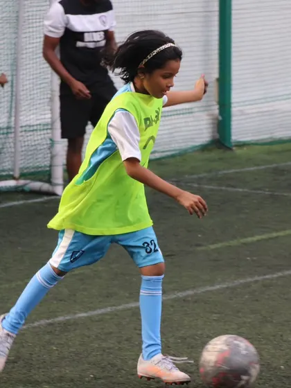 A young player executes a powerful strike during a shooting drill, building the confidence and technique needed to score goals.