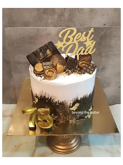 A cake to celebrate 75 glorious years for the "Best Dad". This design combines a modern black and gold fault line style with a topping of his favorite chocolates.