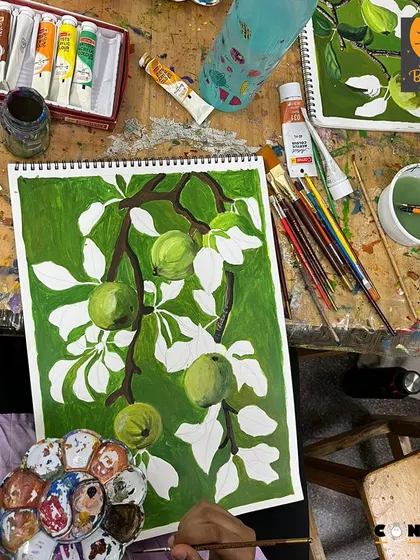 This shot captures the artist's palette and workspace, showing the process of mixing colors for a monochrome painting.