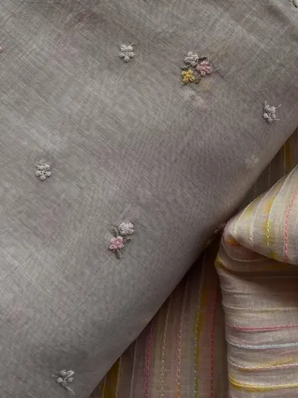 This set of Mul Chanderi fabrics includes a grey embroidered buti design and a coordinating striped fabric, perfect for creating a stylish suit.