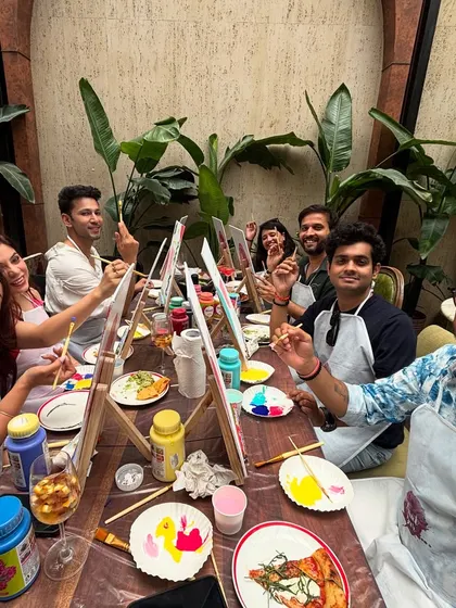 A candid shot from a birthday paint party at a cafe. It's all about good food, good company, and the fun of trying something new together.