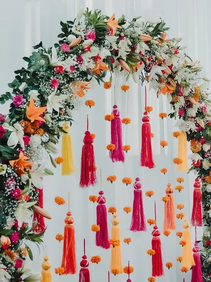 A close-up of the floral arch for the Haldi, with colorful tassels.