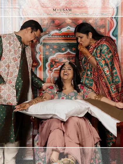 A heartwarming moment between the bride and her parents during the Mehendi. Their playful interaction and her infectious laughter show the deep bond and joy that family brings to a wedding.
